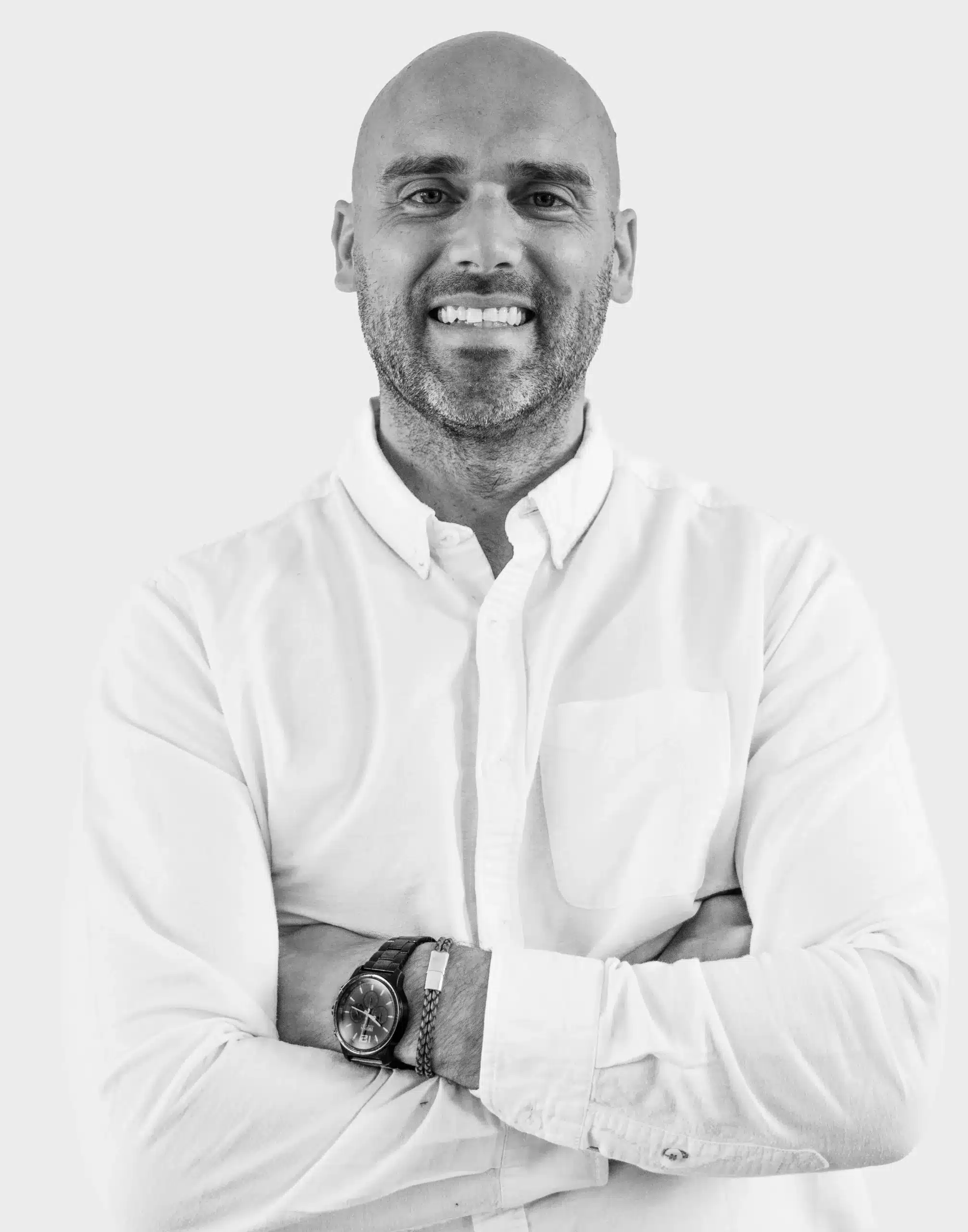 Picture of a doctor with arms crossed in white shirt with white background
