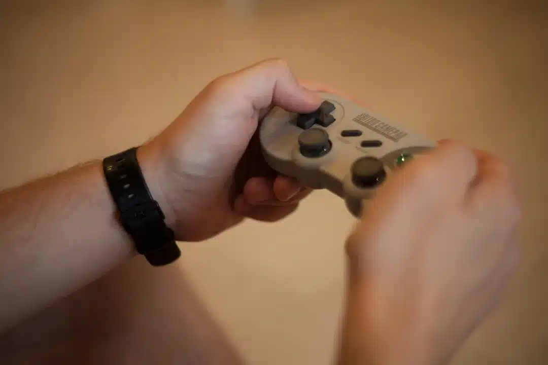 person holding white and black xbox one game controller